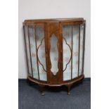 A 1930's walnut D-shaped display cabinet