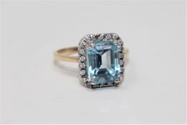 A blue topaz and diamond ring