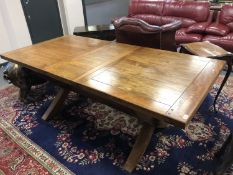 A Barker & Stonehouse hardwood extending dining table on X-frame support, with one leaf,