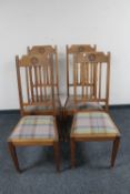 A set of four oak Arts and Crafts dining chairs