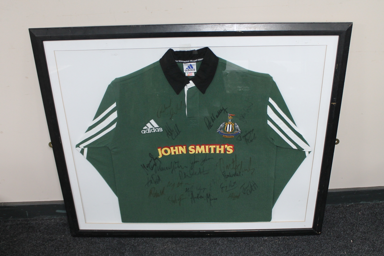 A framed Newcastle Falcons signed rugby shirt