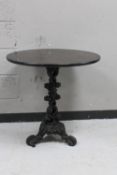 A cast iron bar table with oak top