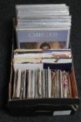 A box of vinyl LP records and 7" singles - Johnny Cash, Walt Disney,