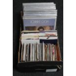 A box of vinyl LP records and 7" singles - Johnny Cash, Walt Disney,