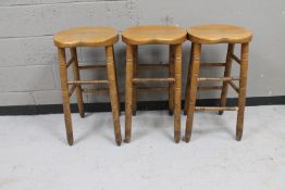 Three wooden bar stools