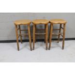 Three wooden bar stools