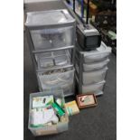 Two plastic storage chests containing extension leads, remote controls,
