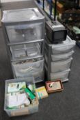 Two plastic storage chests containing extension leads, remote controls,
