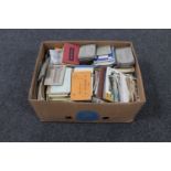 A box of large quantity of antique and later postcards and postcard snap shot books