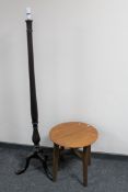 A circular oak occasional table and a mahogany standard lamp