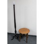 A circular oak occasional table and a mahogany standard lamp
