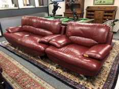 A contemporary three seater red leather settee with matching armchair retailed by Harvey's