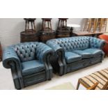 A blue buttoned leather Chesterfield three seater club settee and matching armchair