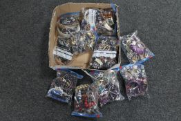 A box containing ten bags of assorted costume jewellery