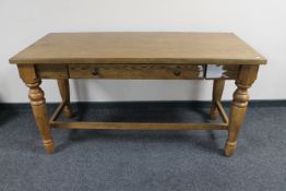 An oak effect kitchen table fitted a drawer