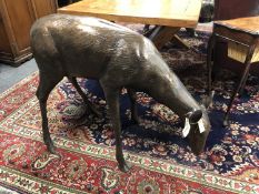 A cast patinated aluminium figure - a doe grazing,