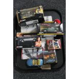 A tray of James Bond collectables - two posters, set of Casino Royale playing cards,