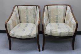 A pair of beech framed armchairs in floral striped fabric