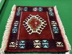 A fringed Caucasian design mat,