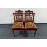 A set of four late Victorian mahogany dining chairs upholstered in tapestry fabric