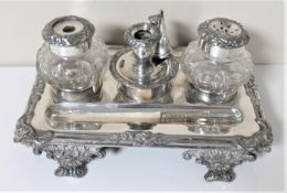 A silver plated desk stand with inkwells and a pen