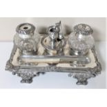 A silver plated desk stand with inkwells and a pen