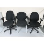 Two adjustable swivel office armchairs and two further office chairs