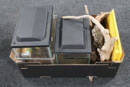 A box of four small vivariums