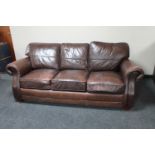 A Barker & Stonehouse brown leather three seater settee