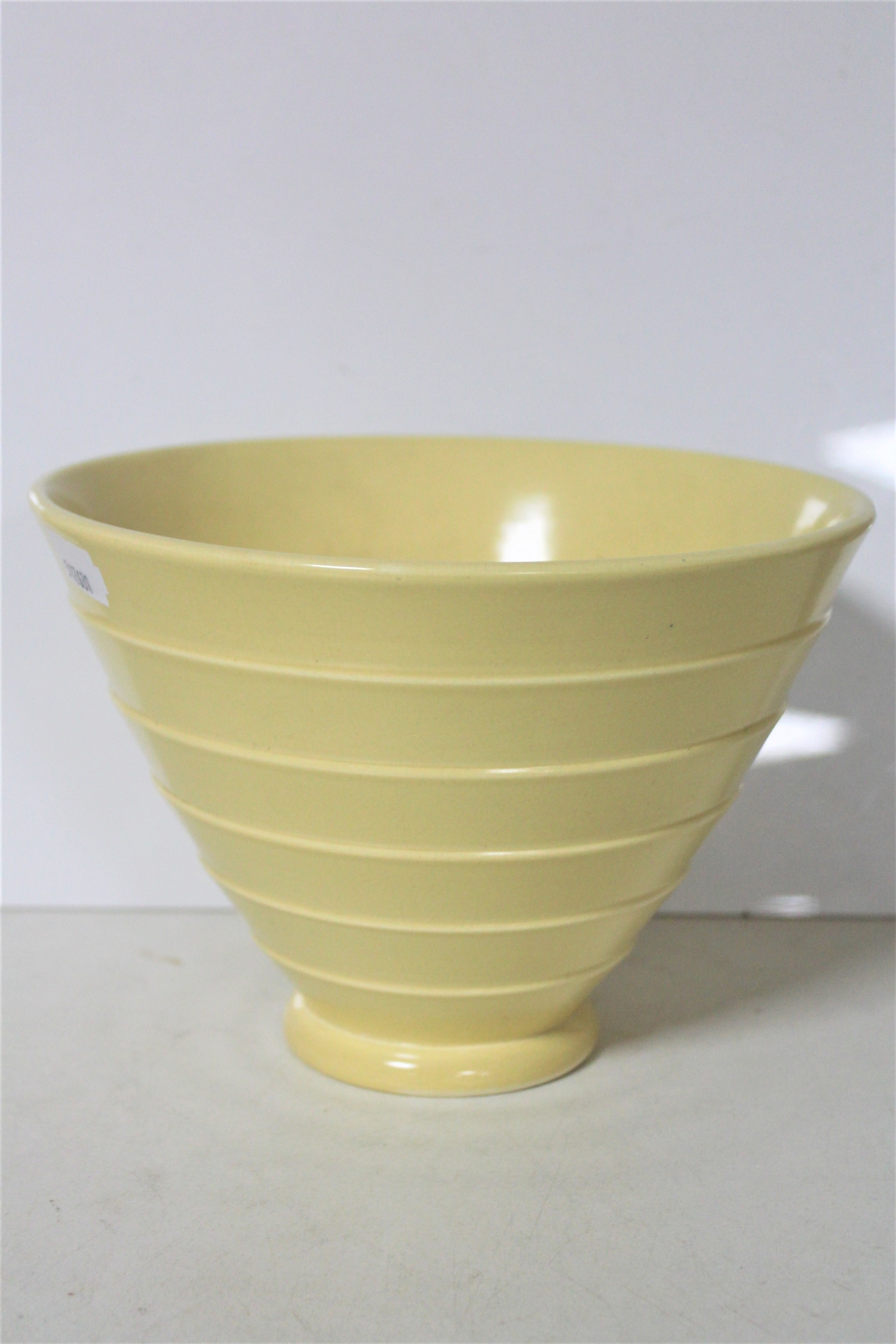 A Wedgwood Keith Murray design conical vase, matt straw,