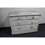 An antique painted pine four drawer chest
