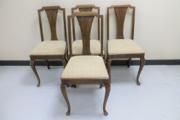 A set of four oak continental dining chairs