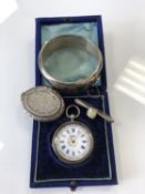 A silver continental fob watch together with a silver bangle, white metal locket and bar brooch.