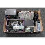 A box of Alcatel digital scales, DP home homes, universal remotes, desk top LCD calendar,