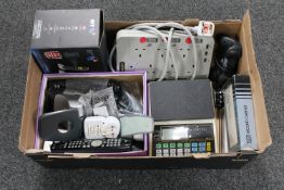 A box of Alcatel digital scales, DP home homes, universal remotes, desk top LCD calendar,