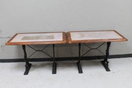 A pair of pub tables on cast iron bases