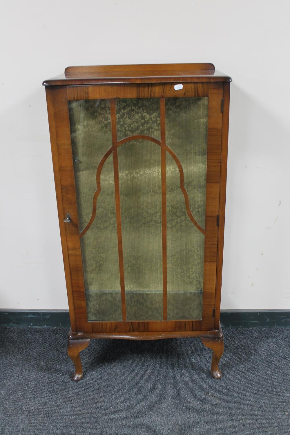 A 1930's walnut single door display cabinet