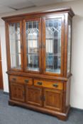 A contemporary oak leaded glass door display cabinet CONDITION REPORT: 211cm high,