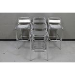 A set of four metal bar stools