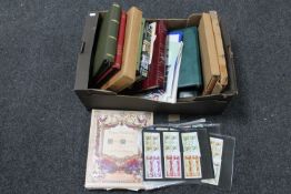 A box of a quantity of stamp albums containing a large collection of assorted stamps,