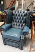 A blue buttoned leather Chesterfield wingback armchair