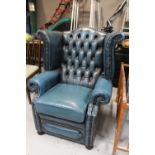 A blue buttoned leather Chesterfield wingback armchair