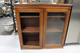 An Edwardian oak bookcase top (one glass pane missing)