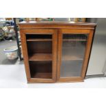 An Edwardian oak bookcase top (one glass pane missing)