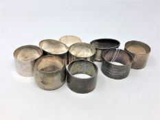 Nine heavy gauge silver serviette rings, 307g.