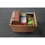 A wicker basket, a vintage luggage case containing drawing instruments, children's building blocks,