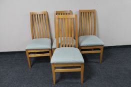 A set of four contemporary rail back dining chairs