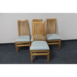 A set of four contemporary rail back dining chairs