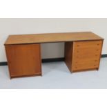 A mid 20th century Danish teak dressing table fitted with a cupboard and five drawers