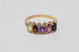 A 9ct gold multi stone ring set with sapphire, rhodalite, amethyst, garnet and peridot.